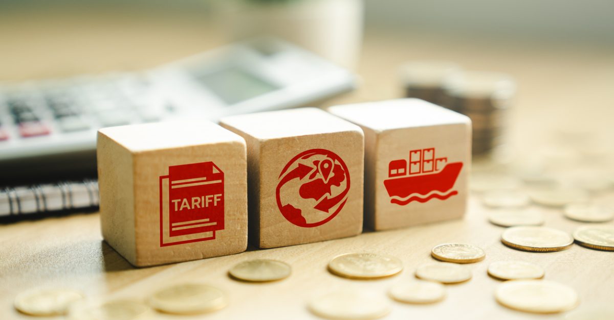 Global trade and tariff concept with red icons on wooden cubes, showing international shipping, customs documentation, and financial implications on import-export and global commerce